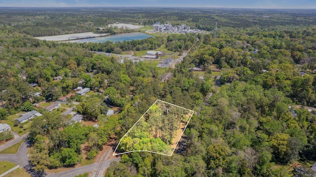 aerial view with a water view and a forest view