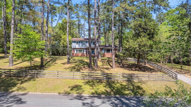 view of front facade featuring a fenced front yard and brick siding
