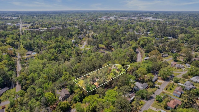 drone / aerial view with a wooded view