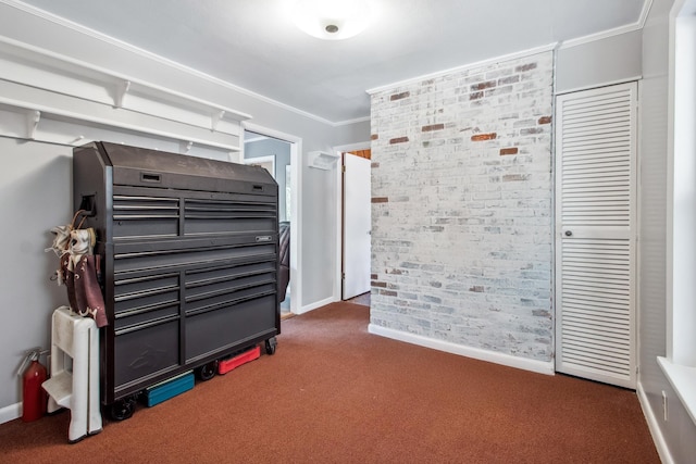 bedroom featuring carpet flooring, ornamental molding, baseboards, and brick wall