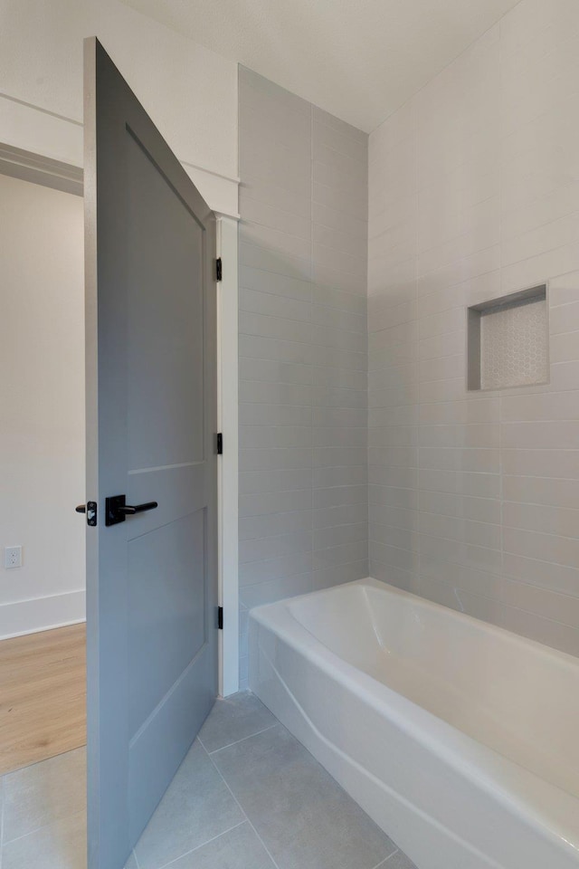 bathroom featuring tile patterned flooring and a bathtub