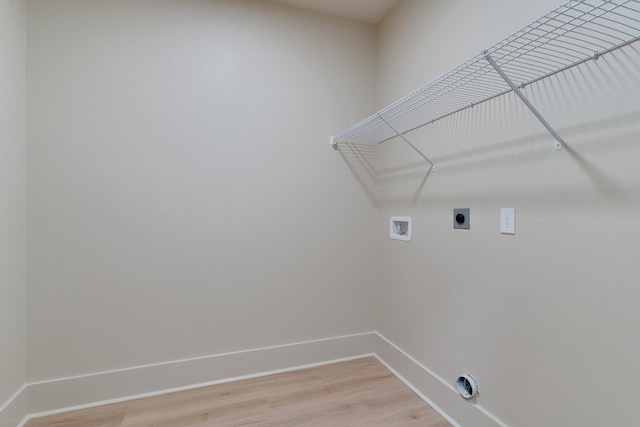 laundry area with electric dryer hookup, hardwood / wood-style floors, and washer hookup