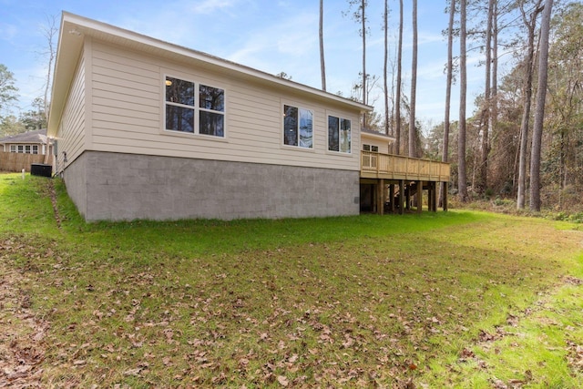 back of house featuring a deck, a yard, and central AC