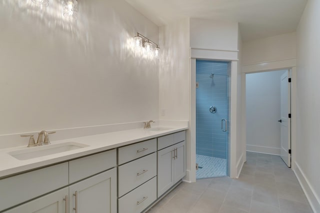 bathroom featuring tile patterned flooring, an enclosed shower, and vanity