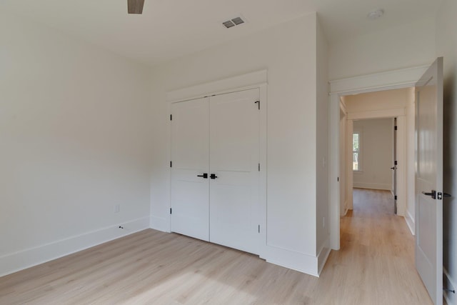 unfurnished bedroom featuring a closet, ceiling fan, and light hardwood / wood-style floors