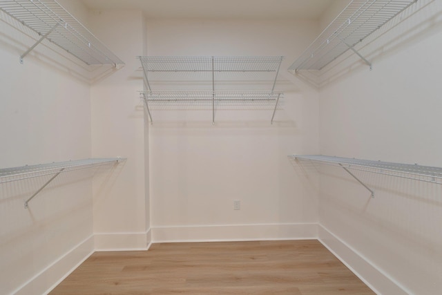 walk in closet with hardwood / wood-style floors