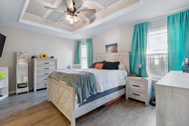 bedroom with light wood-type flooring, multiple windows, coffered ceiling, and ceiling fan