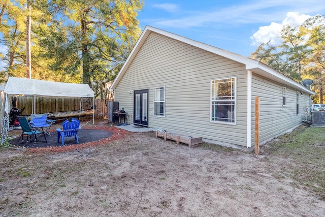 back of property with cooling unit and a patio