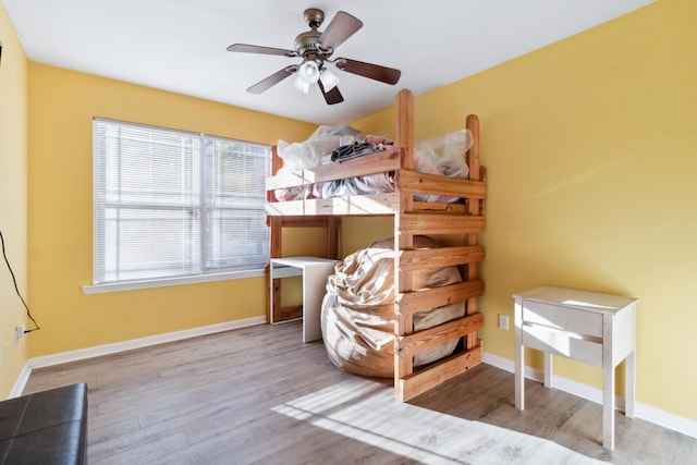 bedroom with light hardwood / wood-style flooring and ceiling fan