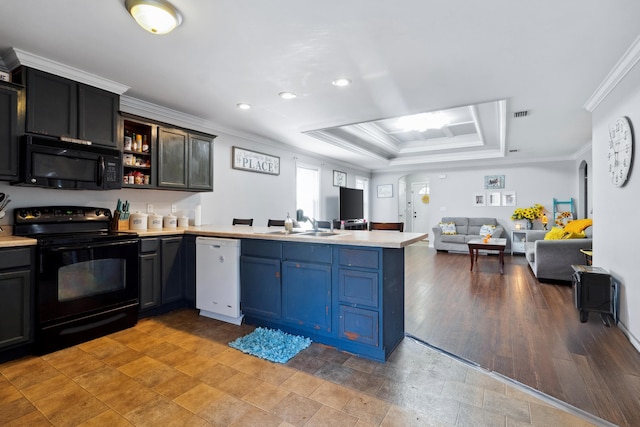 kitchen with black appliances, a raised ceiling, wood-type flooring, crown molding, and kitchen peninsula