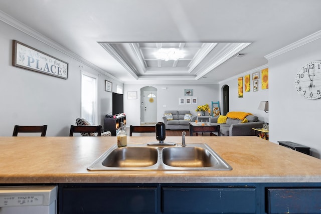 kitchen with a tray ceiling, blue cabinets, crown molding, sink, and dishwasher