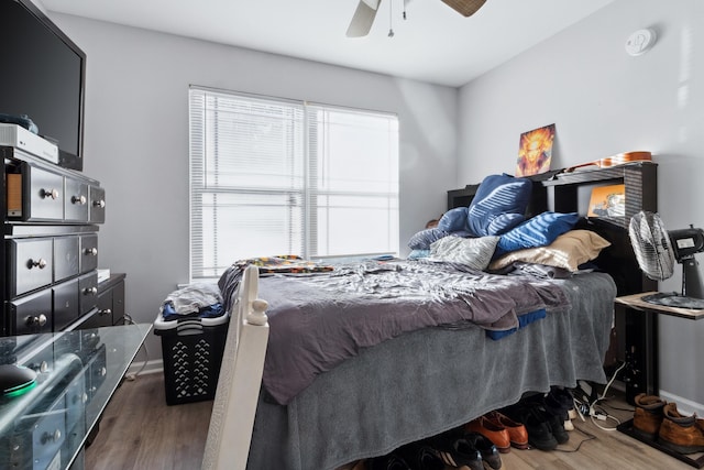 bedroom featuring ceiling fan and dark wood-type flooring