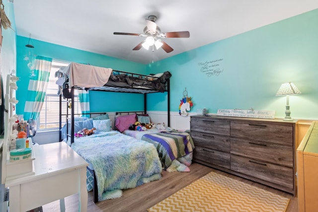 bedroom with ceiling fan and light hardwood / wood-style flooring