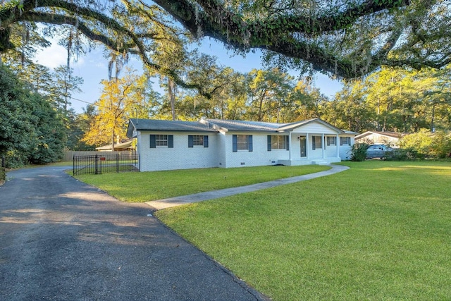 ranch-style house with a porch and a front lawn