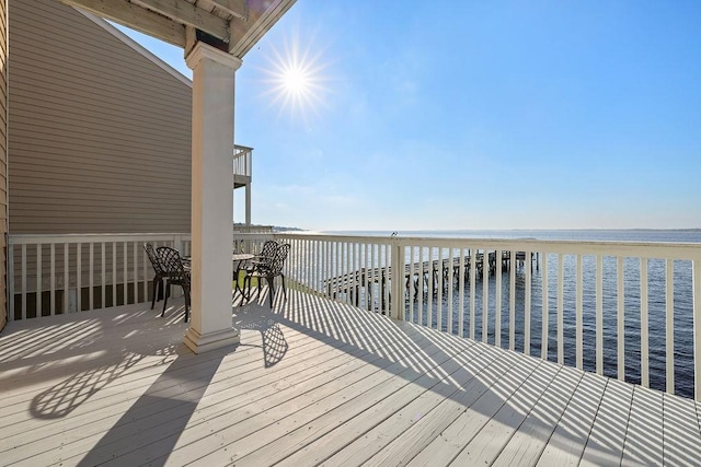 deck featuring a view of the beach and a water view