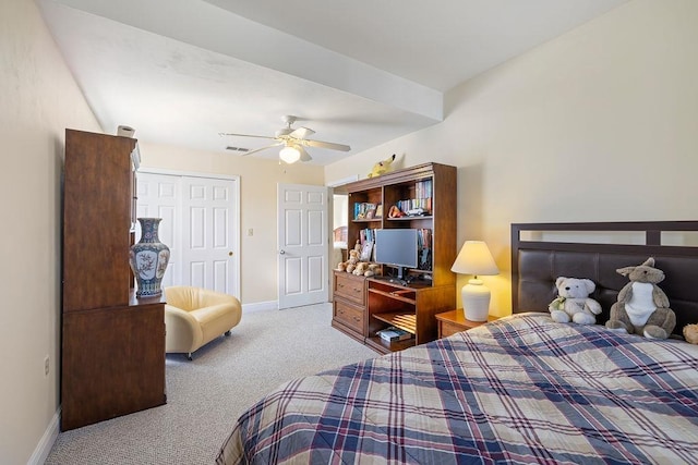 bedroom featuring ceiling fan, light colored carpet, and a closet