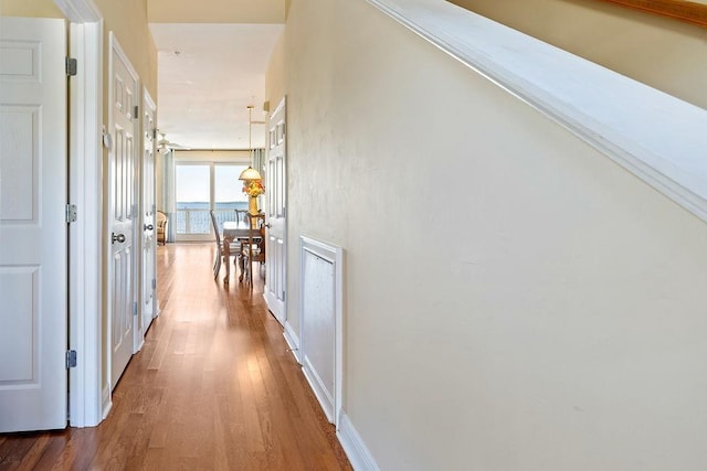 corridor with hardwood / wood-style flooring