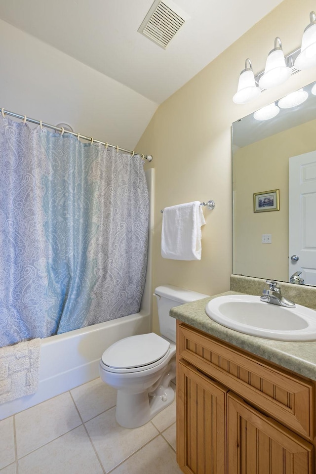 full bathroom featuring tile patterned flooring, lofted ceiling, toilet, shower / bath combo with shower curtain, and vanity