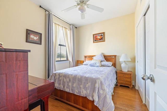 bedroom featuring a closet, light hardwood / wood-style flooring, and ceiling fan