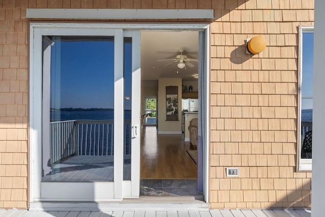 doorway to property featuring ceiling fan