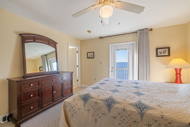 carpeted bedroom with ceiling fan, access to exterior, and a water view