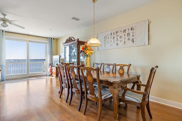 dining space featuring ceiling fan and wood-type flooring