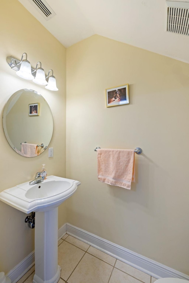 bathroom with tile patterned floors and vaulted ceiling