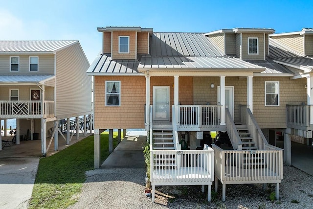 rear view of house featuring covered porch and a carport