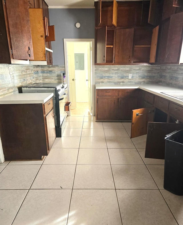 kitchen with light tile patterned floors, range with electric cooktop, and backsplash