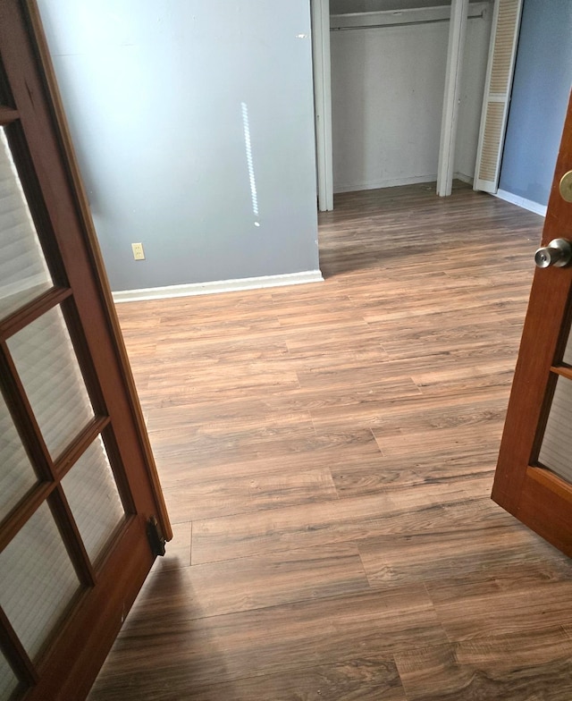 hallway featuring hardwood / wood-style flooring