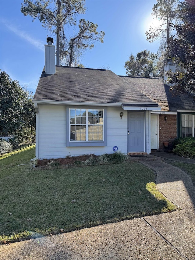 ranch-style house with a front lawn