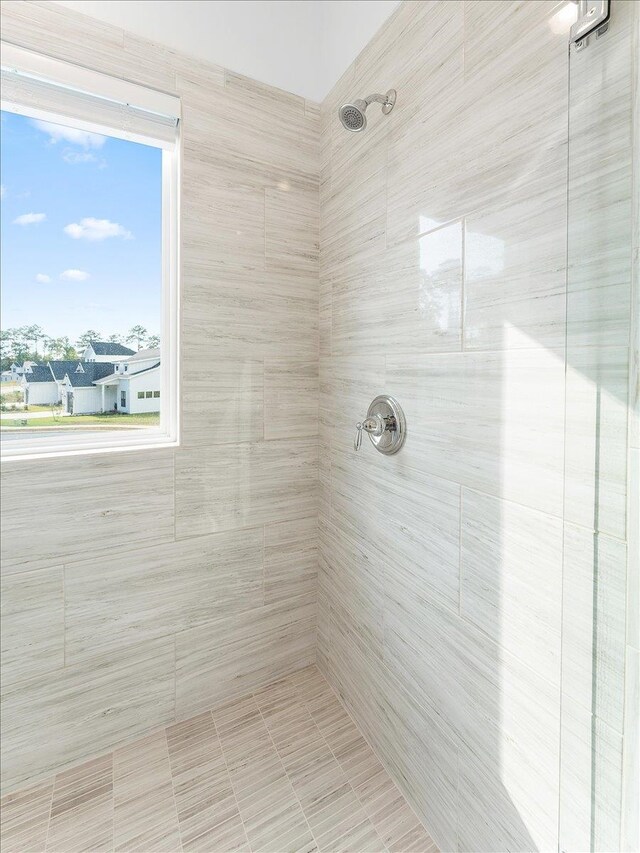 bathroom with a tile shower