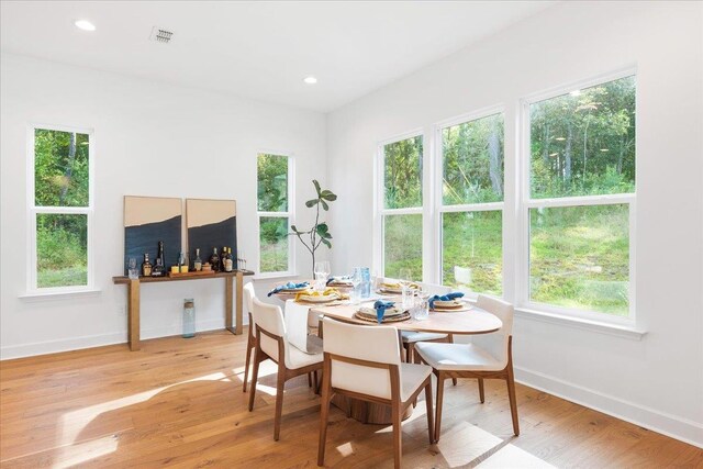 dining room with a wealth of natural light and light hardwood / wood-style flooring