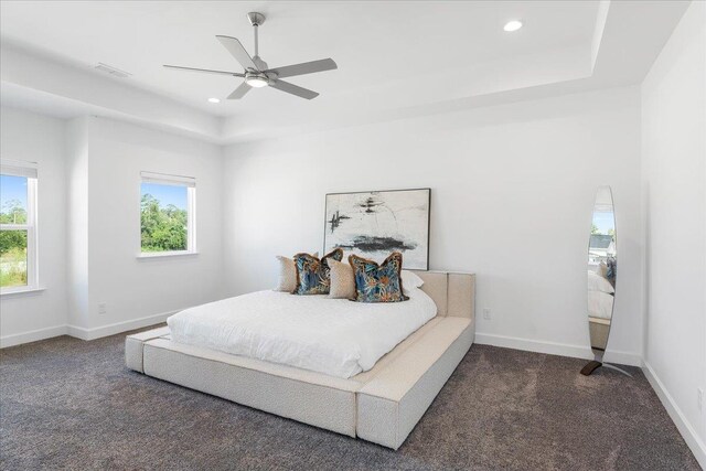 bedroom with ceiling fan and dark carpet