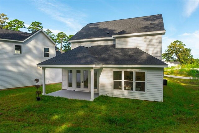 back of house featuring a patio and a yard