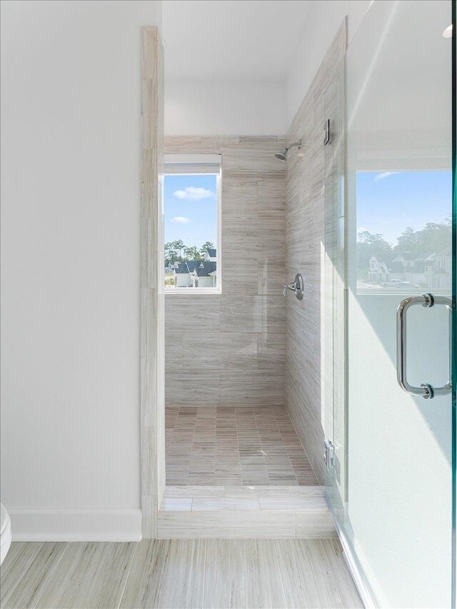 bathroom featuring a shower with shower door