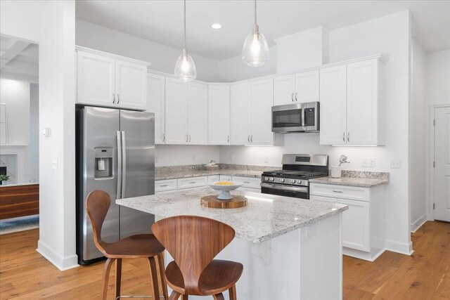 kitchen with white cabinetry, a center island, and stainless steel appliances