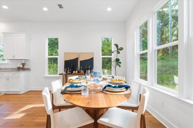 dining room featuring plenty of natural light and light hardwood / wood-style flooring