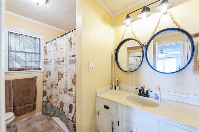 bathroom with a shower with shower curtain, vanity, crown molding, and a textured ceiling