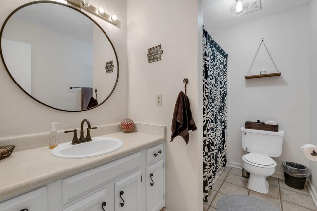 5313 Ben Brush Trl, Tallahassee, FL 32309 - bathroom featuring vanity, toilet, tile patterned flooring, curtained shower, and baseboards