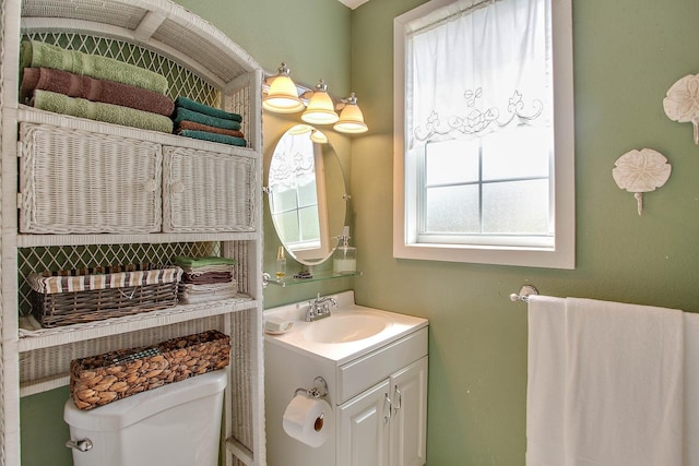 bathroom featuring vanity and toilet