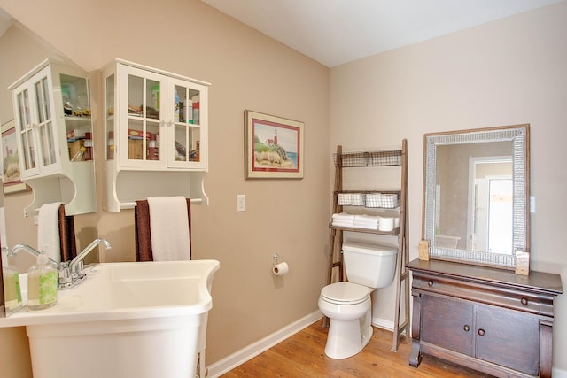 bathroom featuring hardwood / wood-style floors, sink, and toilet