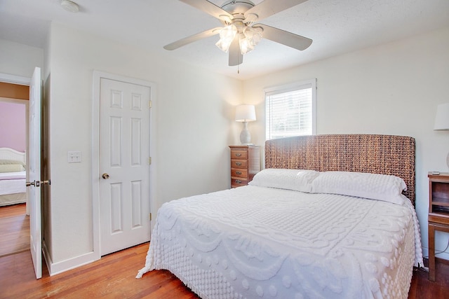 bedroom with hardwood / wood-style floors and ceiling fan