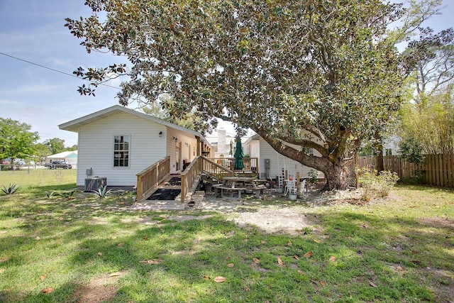 rear view of property featuring a lawn