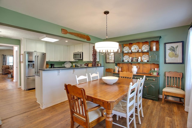 dining room featuring a notable chandelier and hardwood / wood-style flooring