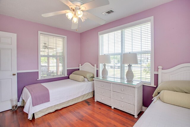 bedroom with ceiling fan and dark hardwood / wood-style floors