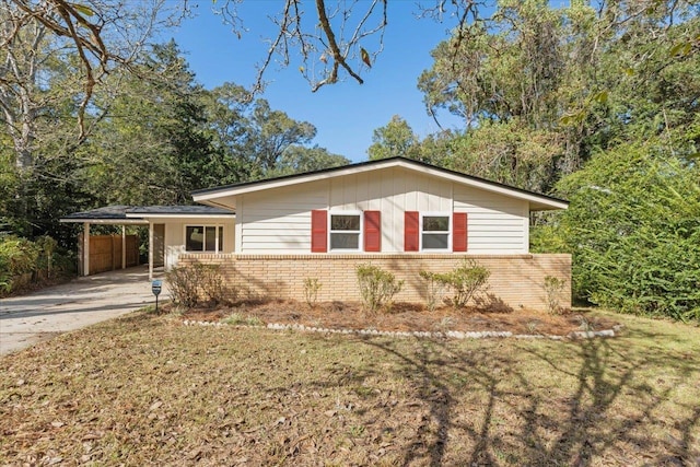 ranch-style house featuring a carport and a front yard