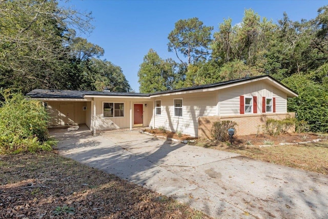 ranch-style home featuring a carport