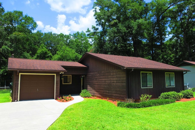 5491 Denargo Dr, Tallahassee, FL 32303 - view of front facade featuring an attached garage, concrete driveway, a front lawn, and roof with shingles