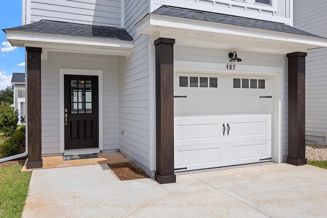 doorway to property with a garage